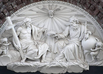 The sculpted pediment (white marble) – representing the Holy Trinity - surmounting the main altar in the Cathedral of Our Lady in Antwerp.  This house of worship is the largest Gothic building in the Netherlands.